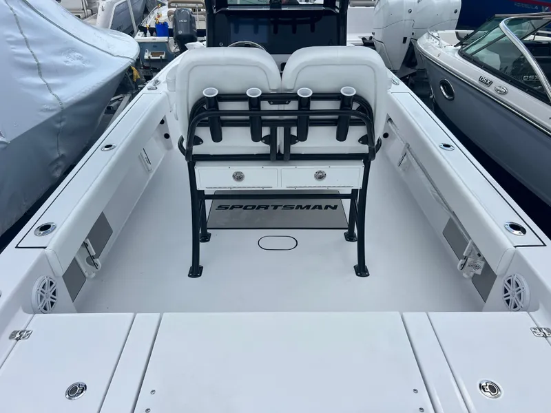 Slide: The Image of 2025 Sportsman Masters 247OE Bay Boat interior with seating and storage compartments. - 6