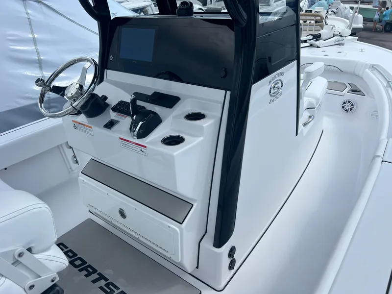 Slide: The Image of 2025 Sportsman Masters 247OE Bay Boat console with steering wheel and controls. - 9
