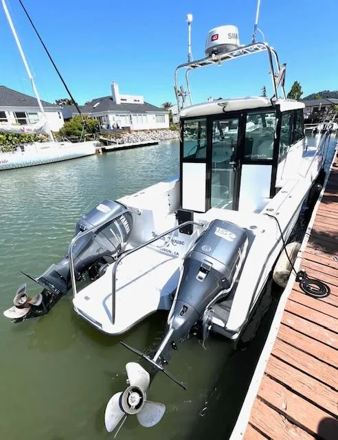 Slide: The Image of 2002 Glacier Bay 2690 Coastal Runner docked with dual outboard motors. - 1