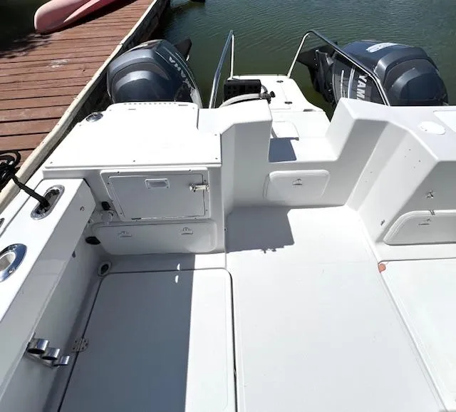 Slide: The Image of 2002 Glacier Bay 2690 Coastal Runner boat interior with twin outboard motors. - 10