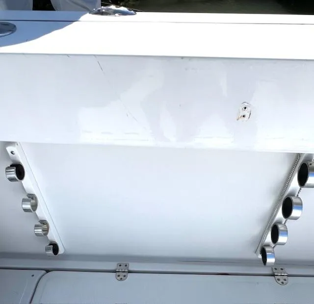 Slide: The Image of 2002 Glacier Bay 2690 Coastal Runner boat interior with rod holders. - 13