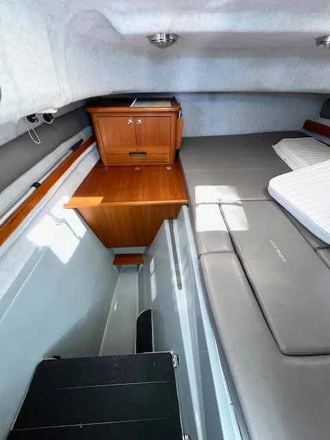 Slide: The Image of Interior of 2002 Glacier Bay 2690 Coastal Runner, featuring cabin with wooden cabinetry and seating. - 15