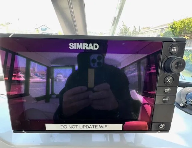 Slide: The Image of Simrad display on 2002 Glacier Bay 2690 Coastal Runner with "Do Not Update WiFi" message. - 17