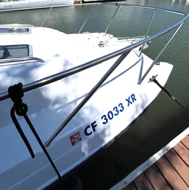 Slide: The Image of 2002 Glacier Bay 2690 Coastal Runner boat docked, displaying registration number CF 3033 XR. - 4