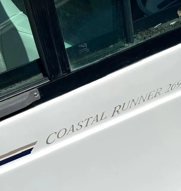 Slide: The Image of 2002 Glacier Bay 2690 Coastal Runner boat, close-up of name and window. - 5