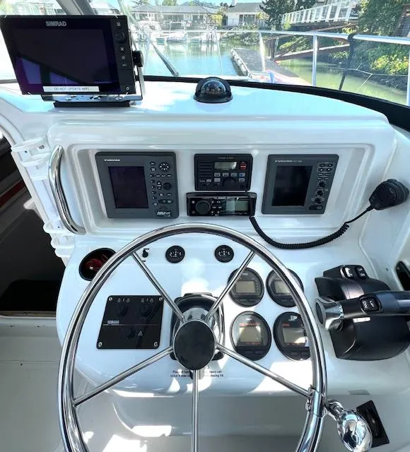 Slide: The Image of Helm of 2002 Glacier Bay 2690 Coastal Runner with navigation equipment and steering wheel. - 8