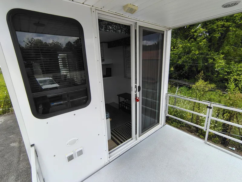 Slide: The Image of 2017 Catamaran Cruisers Lil Hobo 31 houseboat with sliding glass door and outdoor deck. - 10