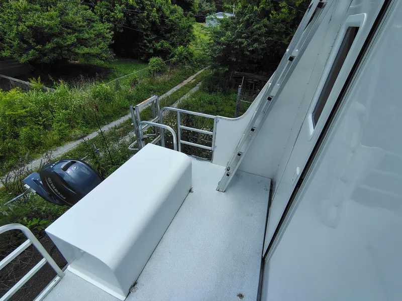 Slide: The Image of 2017 Catamaran Cruisers Lil Hobo 31 deck with railing and outboard motor. - 13