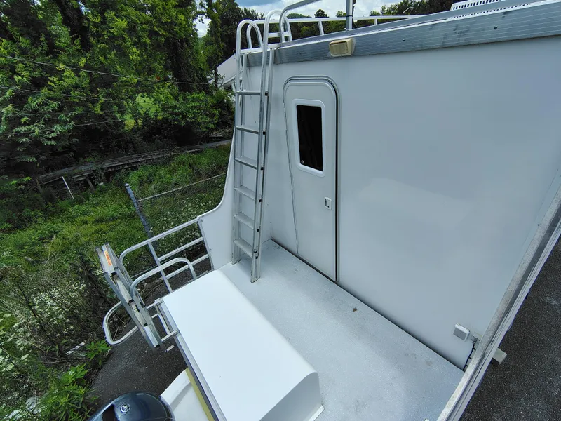 Slide: The Image of 2017 Catamaran Cruisers Lil Hobo 31 houseboat with exterior ladder and railing. - 14
