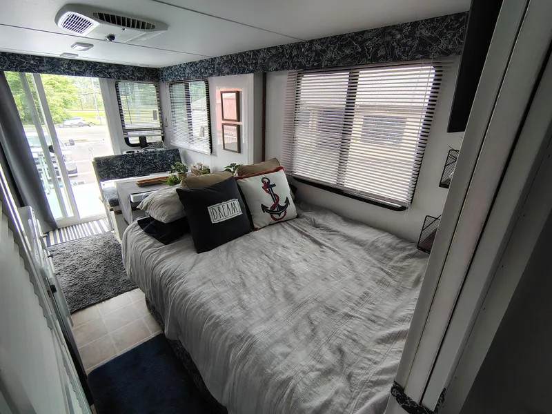 Slide: The Image of Interior of 2017 Catamaran Cruisers Lil Hobo 31 with cozy bed and nautical decor. - 3