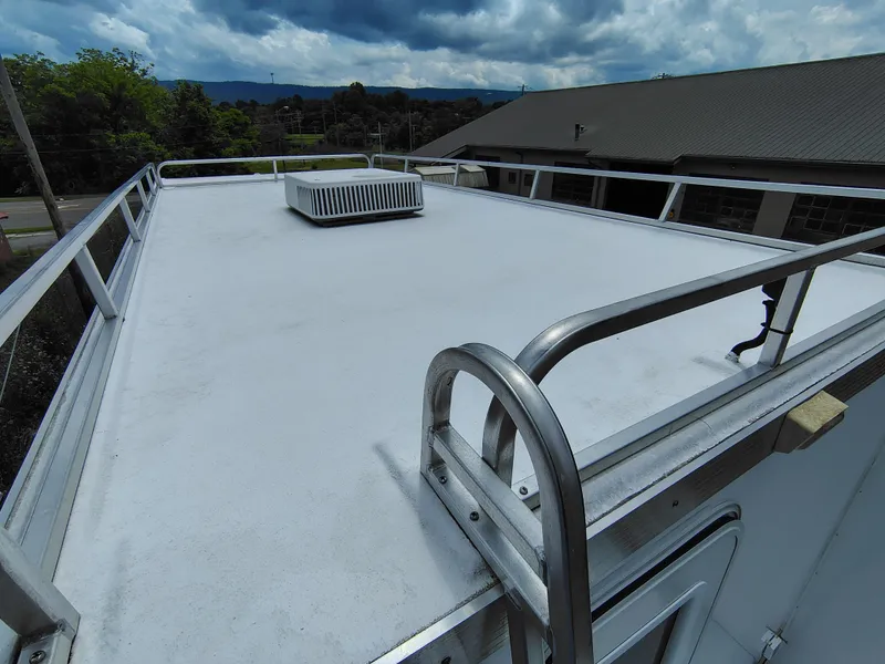 Slide: The Image of Rooftop view of 2017 Catamaran Cruisers Lil Hobo 31 houseboat under cloudy sky. - 9