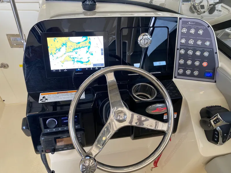 Slide: The Image of 2026 Scout 255 Dorado boat dashboard with Garmin navigation and control panel. - 7