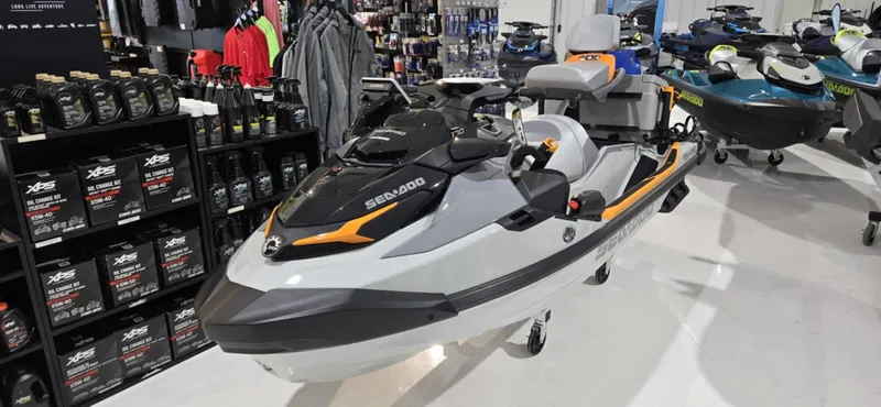 Slide: The Image of 2025 Sea-Doo Fishpro Trophy 170 on display in a showroom with accessories. - 1
