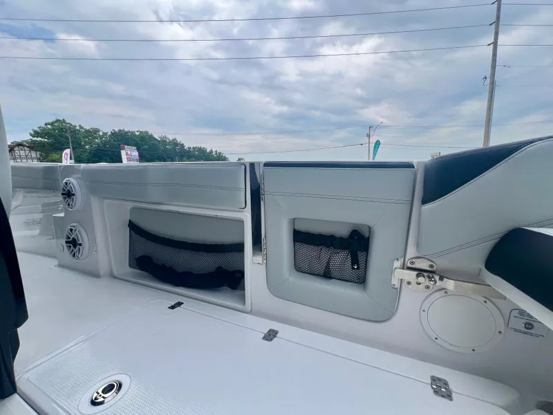 Slide: The Image of 2025 Nor-Tech 340 Sport Center Console interior with storage compartments and speakers. - 13