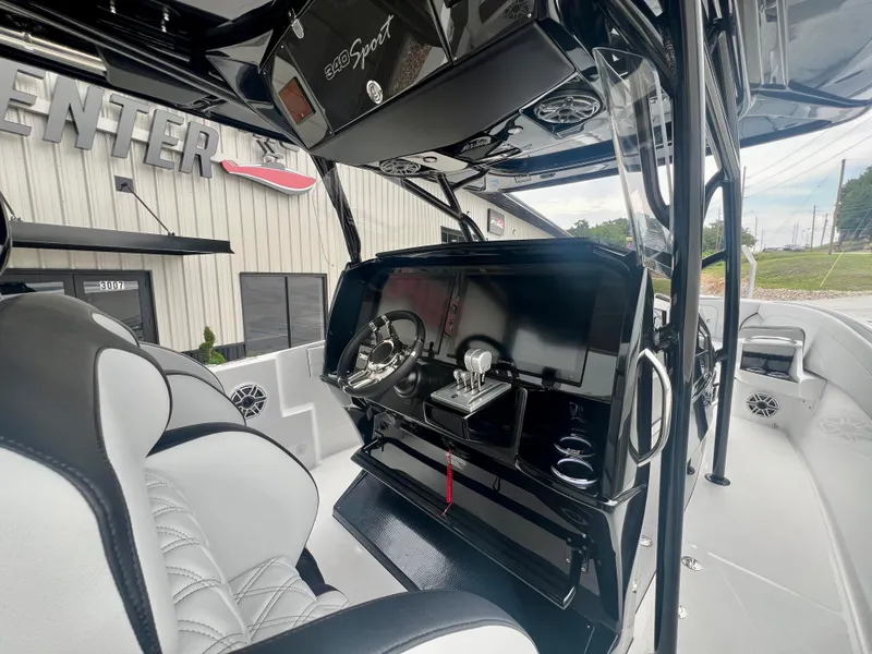 Slide: The Image of 2025 Nor-Tech 340 Sport Center Console boat interior with sleek dashboard and seating. - 16