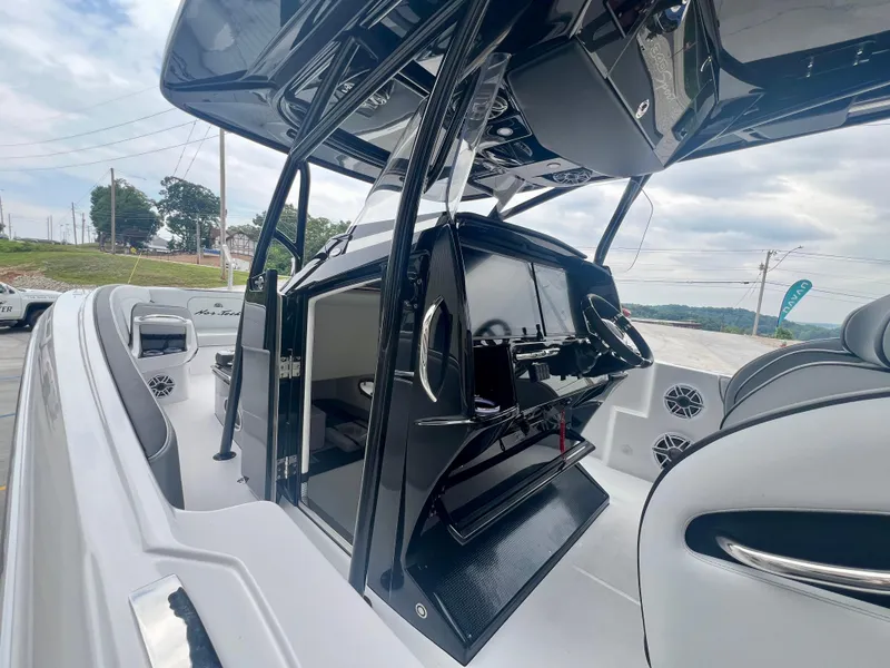 Slide: The Image of 2025 Nor-Tech 340 Sport Center Console boat interior with sleek design and modern controls. - 18