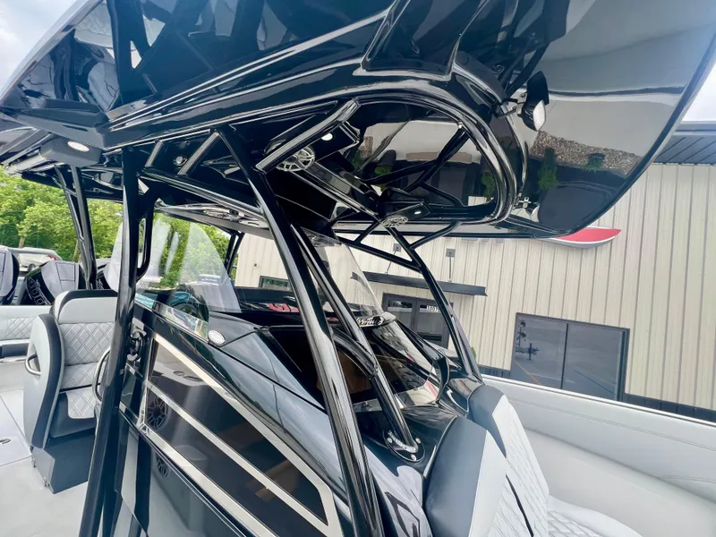 Slide: The Image of 2025 Nor-Tech 340 Sport Center Console, sleek black design, modern interior, outdoor setting. - 19