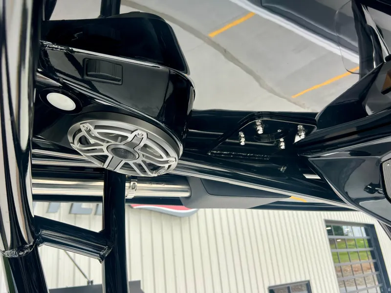 Slide: The Image of 2025 Nor-Tech 340 Sport Center Console, black speaker detail, sleek design, modern marine technology. - 21