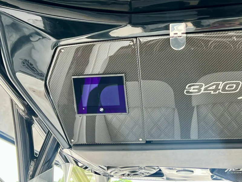 Slide: The Image of 2025 Nor-Tech 340 Sport Center Console dashboard with digital display and sleek design. - 22