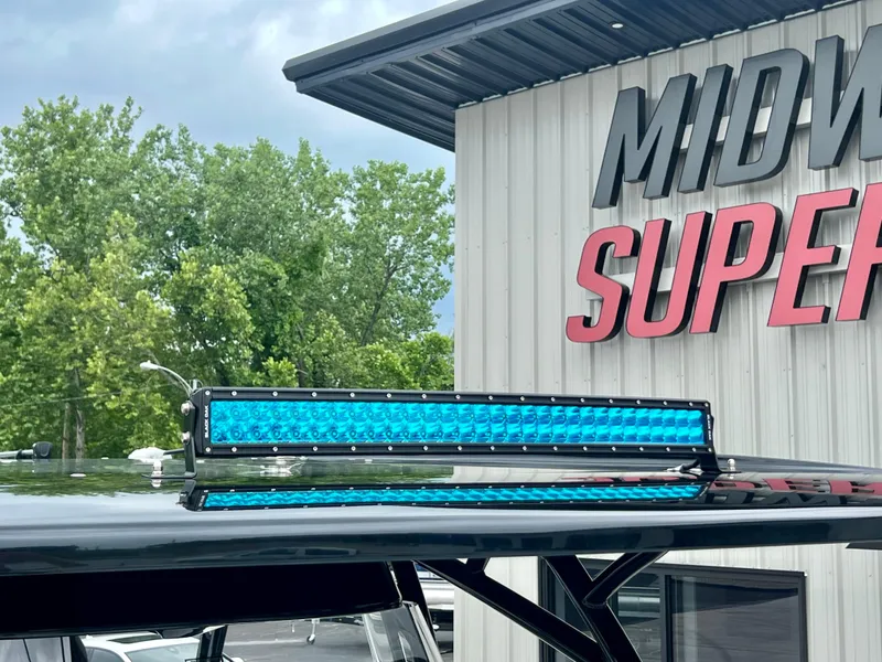 Slide: The Image of 2025 Nor-Tech 340 Sport Center Console with blue LED light bar, Midway Superstore background. - 28