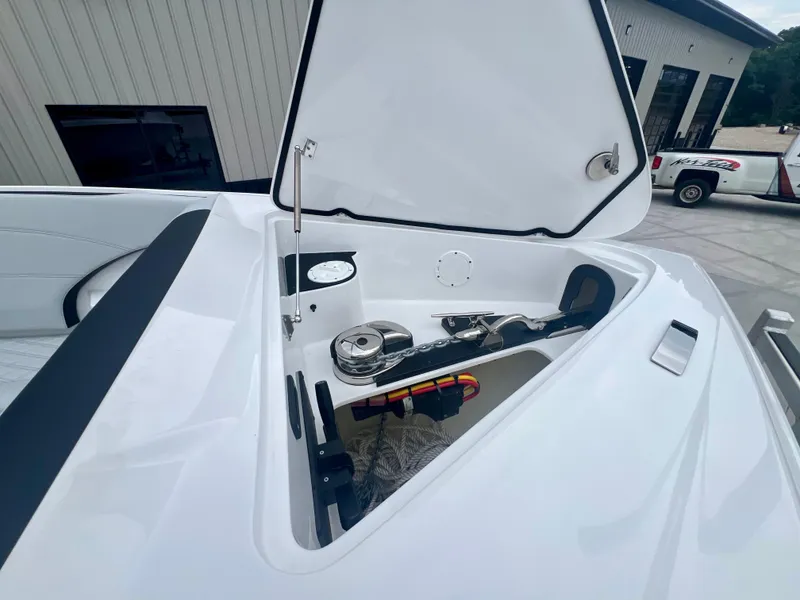 Slide: The Image of 2025 Nor-Tech 340 Sport Center Console boat with open storage compartment. - 31