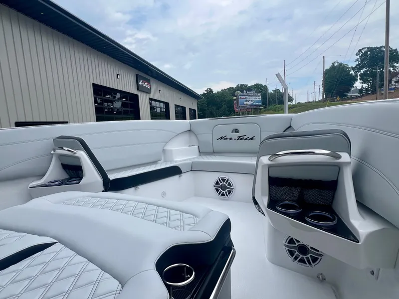 Slide: The Image of 2025 Nor-Tech 340 Sport Center Console interior with white seating and cup holders. - 32