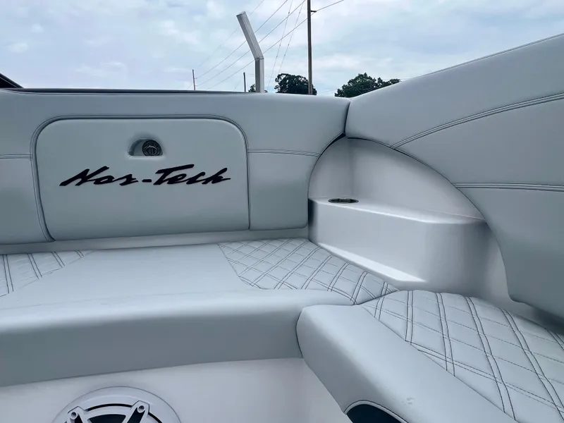 Slide: The Image of 2025 Nor-Tech 340 Sport Center Console interior with white seating and logo detail. - 34