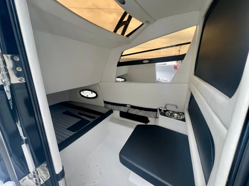 Slide: The Image of 2025 Nor-Tech 340 Sport Center Console cabin interior with sleek seating and modern design. - 40