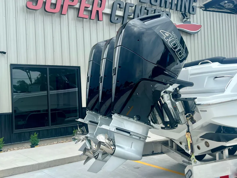 Slide: The Image of 2025 Nor-Tech 340 Sport Center Console with powerful outboard engines at a dealership. - 48