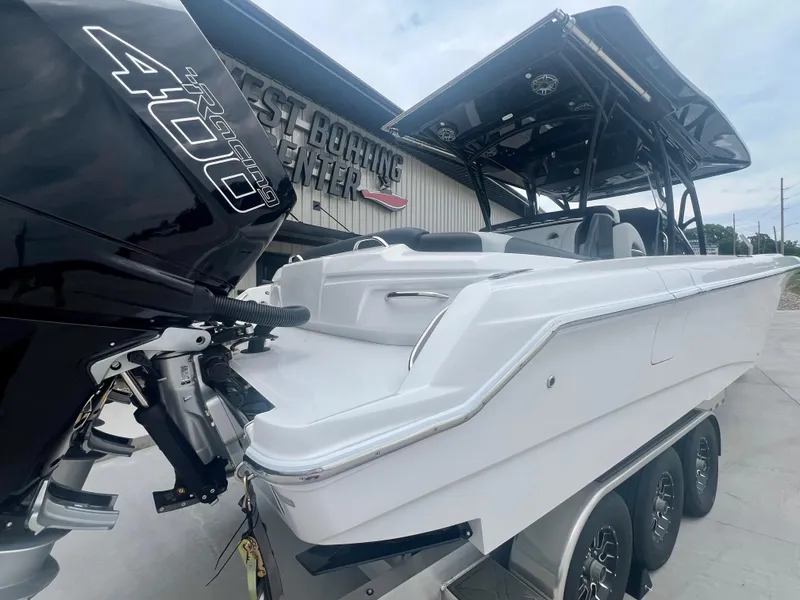 Slide: The Image of 2025 Nor-Tech 340 Sport Center Console boat with powerful engine, showcased at a boating center. - 5