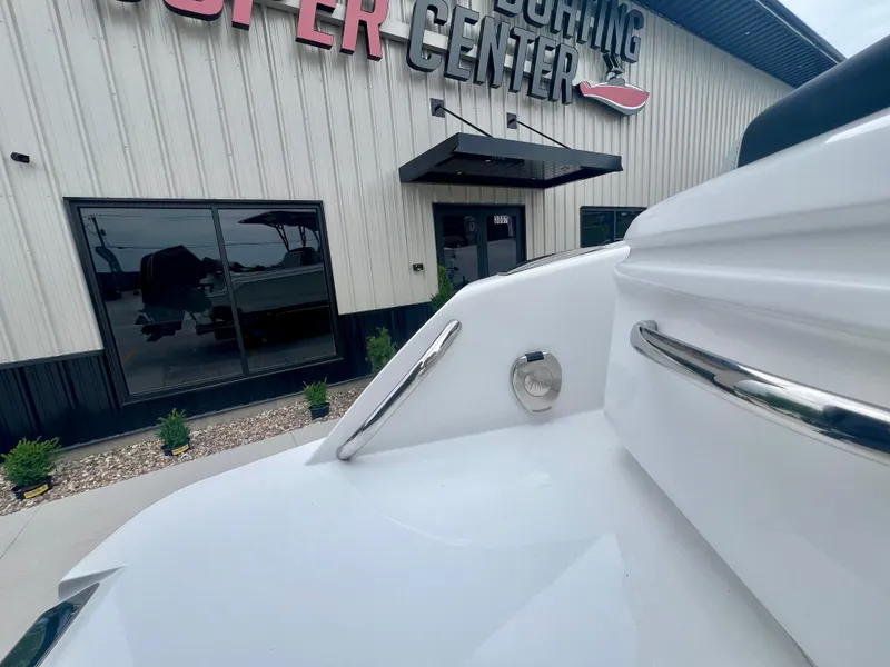 Slide: The Image of 2025 Nor-Tech 340 Sport Center Console boat near a marine center entrance. - 7