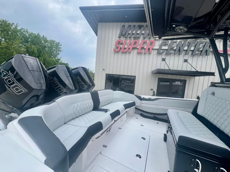 Slide: The Image of 2025 Nor-Tech 340 Sport Center Console boat with triple 400 engines at marina. - 8