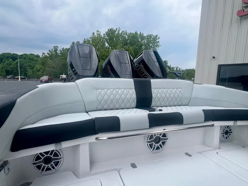 Slide: The Image of 2025 Nor-Tech 340 Sport Center Console boat with luxurious seating and powerful engines. - 9