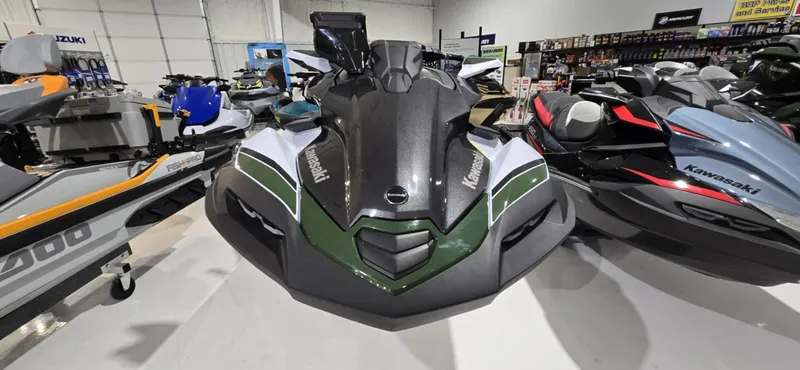 Slide: The Image of 2025 Kawasaki Jetski Ultra 160 LX-S Angler displayed in a showroom with other models. - 2