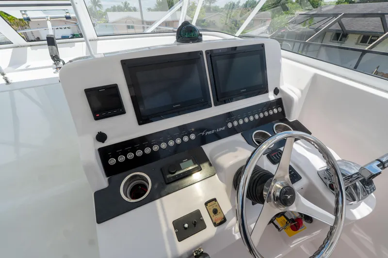 Slide: The Image of 2007 Pro-Line 35 Express boat dashboard with dual screens and steering wheel. - 11