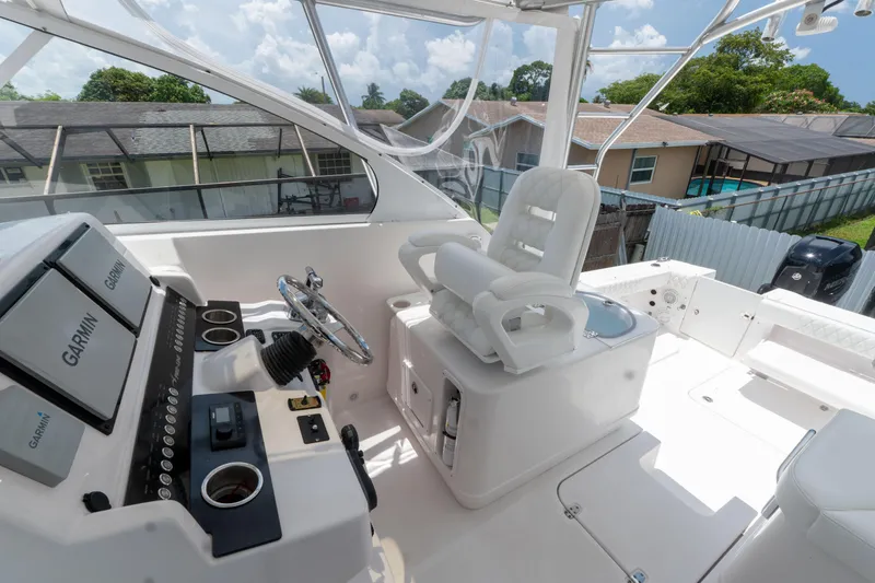 Slide: The Image of 2007 Pro-Line 35 Express boat cockpit with Garmin navigation system and captain's chair. - 12