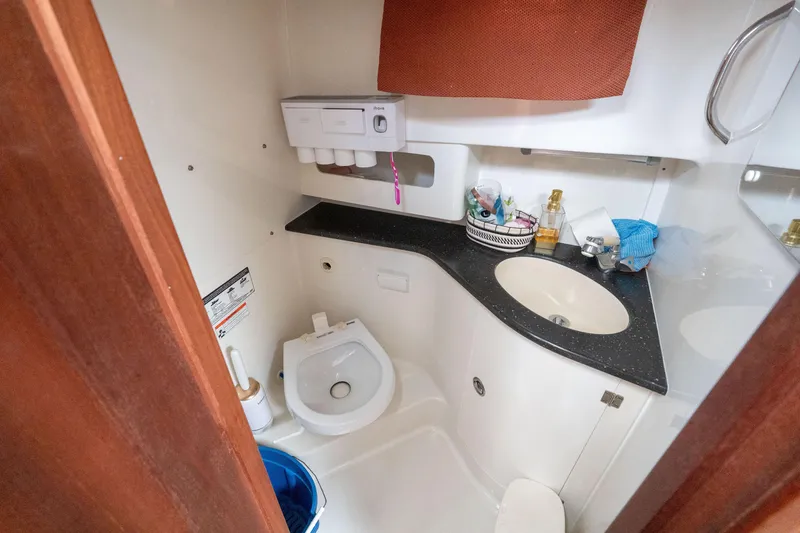 Slide: The Image of 2007 Pro-Line 35 Express boat bathroom with sink, toilet, and storage. - 19