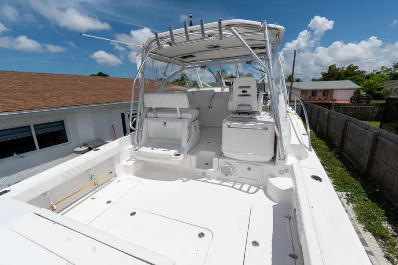 Slide: The Image of 2007 Pro-Line 35 Express boat with spacious deck and seating under clear blue sky. - 3