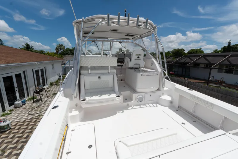 Slide: The Image of 2007 Pro-Line 35 Express boat with spacious deck and seating, docked under clear blue skies. - 5