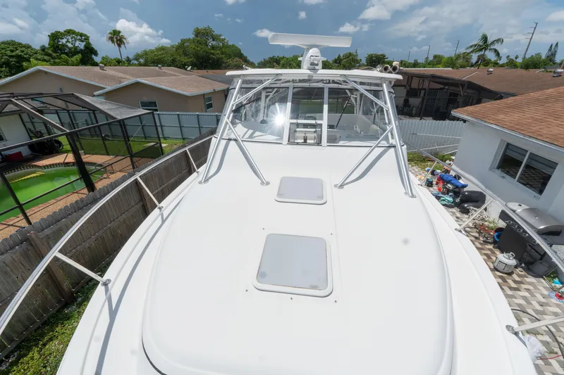 Slide: The Image of 2007 Pro-Line 35 Express boat on land, surrounded by residential homes and clear skies. - 6
