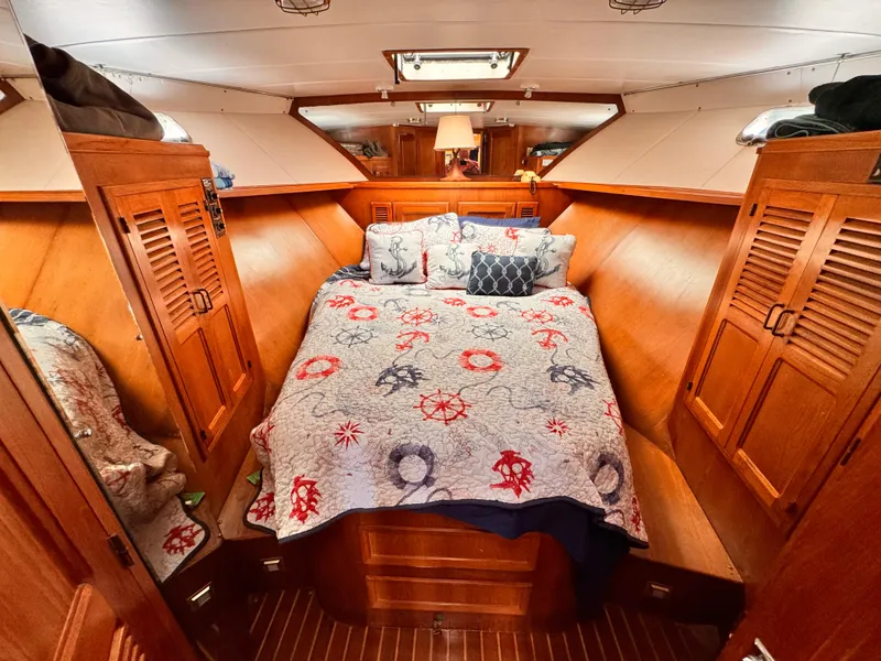 Slide: The Image of Luxurious cabin interior of 1985 Symbol 51 Cockpit Motor Yacht with nautical-themed bedding. - 10