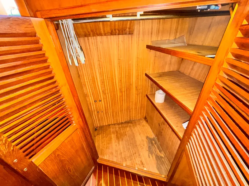 Slide: The Image of Wooden closet interior on 1985 Symbol 51 Cockpit Motor Yacht with shelves and hangers. - 15