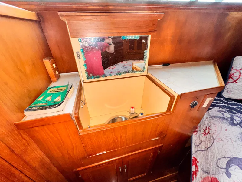 Slide: The Image of 1985 Symbol 51 Cockpit Motor Yacht interior with wooden cabinetry and small sink area. - 16