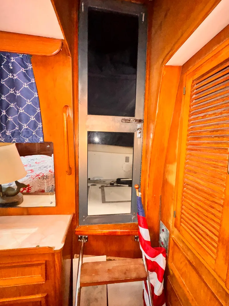 Slide: The Image of Interior of 1985 Symbol 51 Cockpit Motor Yacht with wooden cabinetry and window. - 17