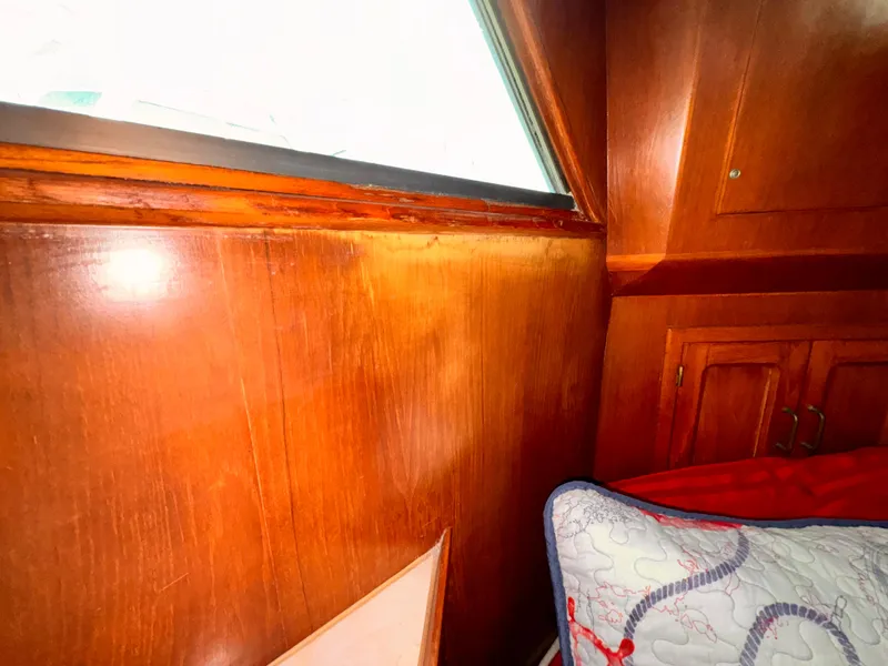 Slide: The Image of Interior of 1985 Symbol 51 Cockpit Motor Yacht with wood paneling and bedding. - 18