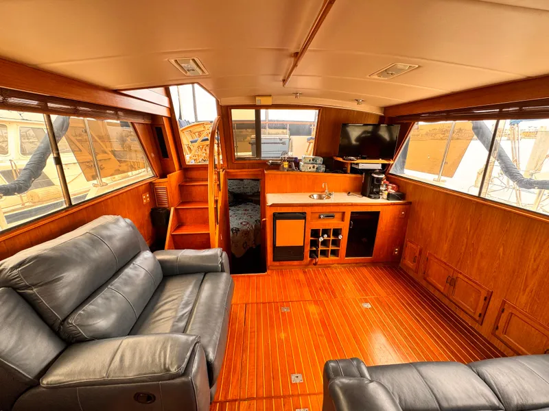 Slide: The Image of Luxurious 1985 Symbol 51 Cockpit Motor Yacht interior with leather seating and wood finishes. - 2