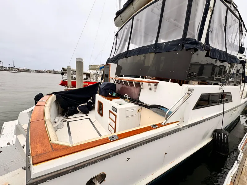 Slide: The Image of 1985 Symbol 51 Cockpit Motor Yacht docked at marina, showcasing spacious deck and sleek design. - 20
