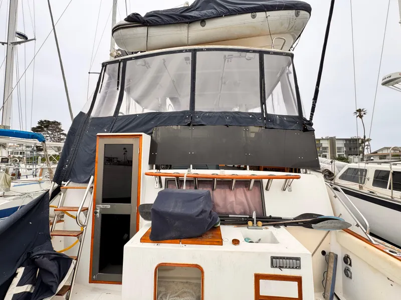 Slide: The Image of 1985 Symbol 51 Cockpit Motor Yacht with covered upper deck and visible entryway. - 21