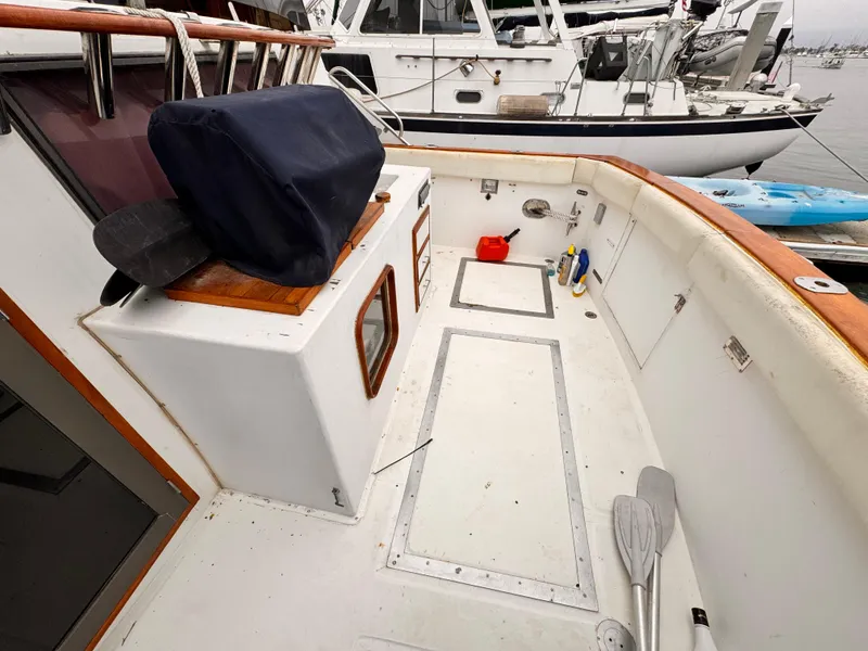 Slide: The Image of 1985 Symbol 51 Cockpit Motor Yacht deck with paddles and equipment, docked at marina. - 22