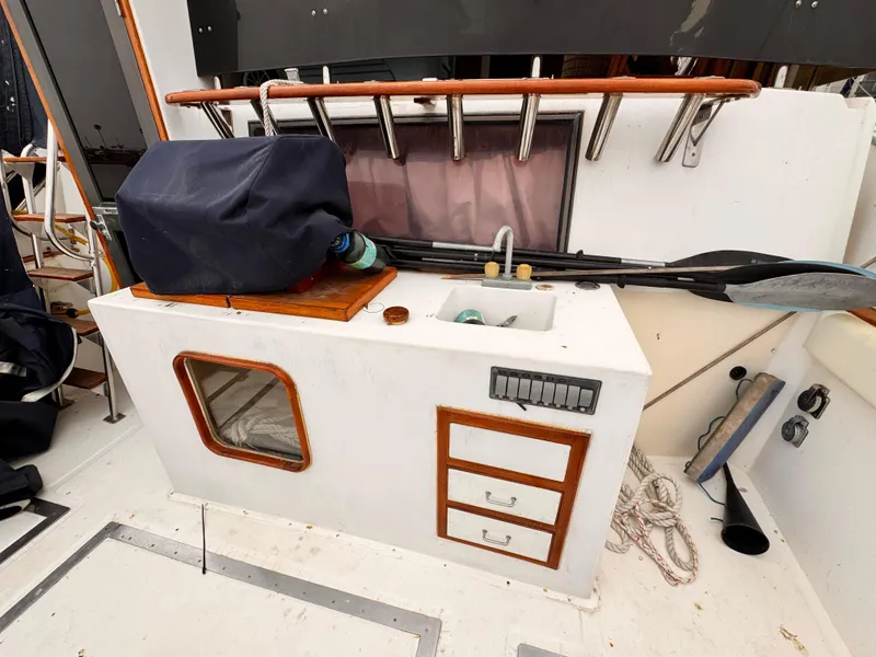 Slide: The Image of 1985 Symbol 51 Cockpit Motor Yacht interior with sink, storage, and fishing rod holders. - 23